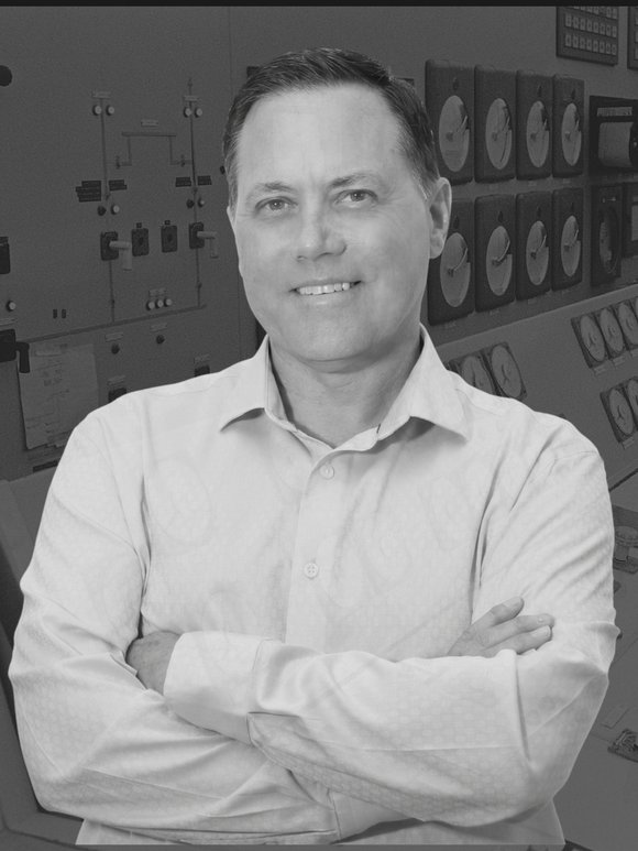 Kendall Peterson, author, standing in a nuclear plant control room